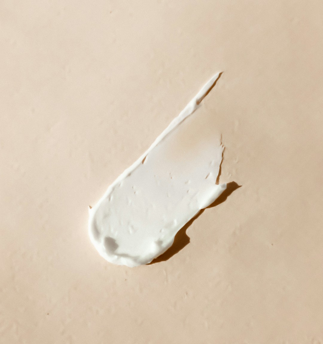 Close-up cream texture illustrating sunscreen and topical pigmentation care